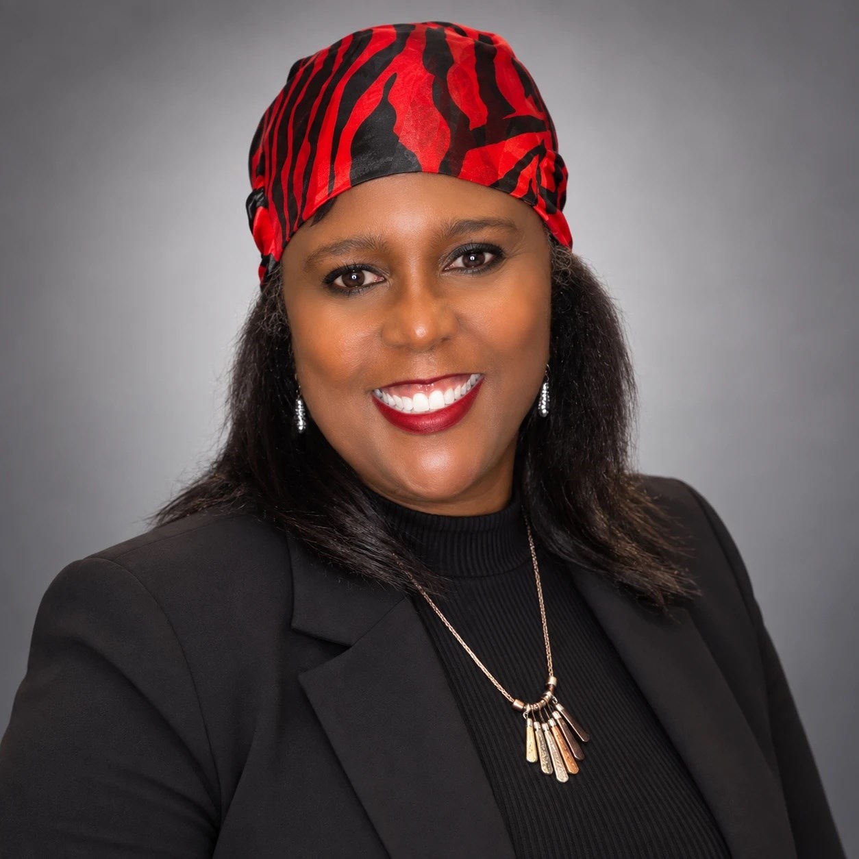 Angela Hamilton, founder and CEO of APH Athletic Fashions, in a black blazer